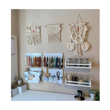 Load image into Gallery viewer, Fiber art decor and the macrame wristlets displayed in office decor inspiration. 

